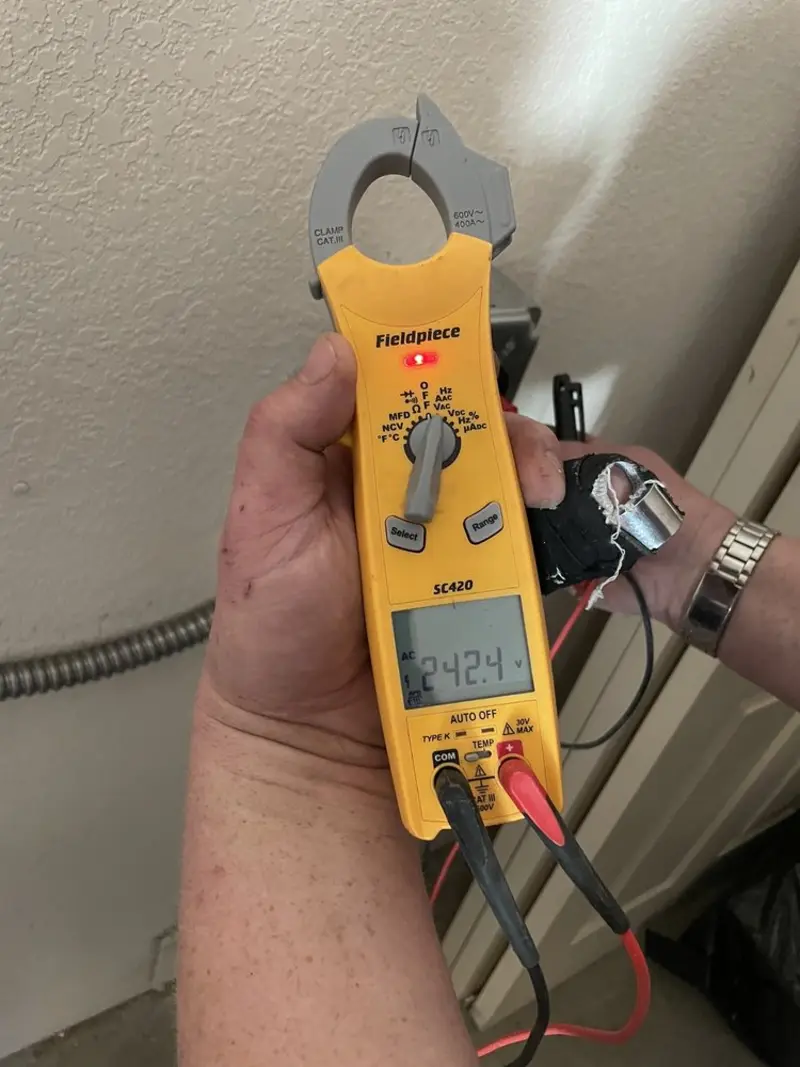 Voltage testing with clamp meter during Outlet Installation in Inglewood